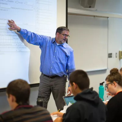 A professor lecturing about accounting concepts to a class.