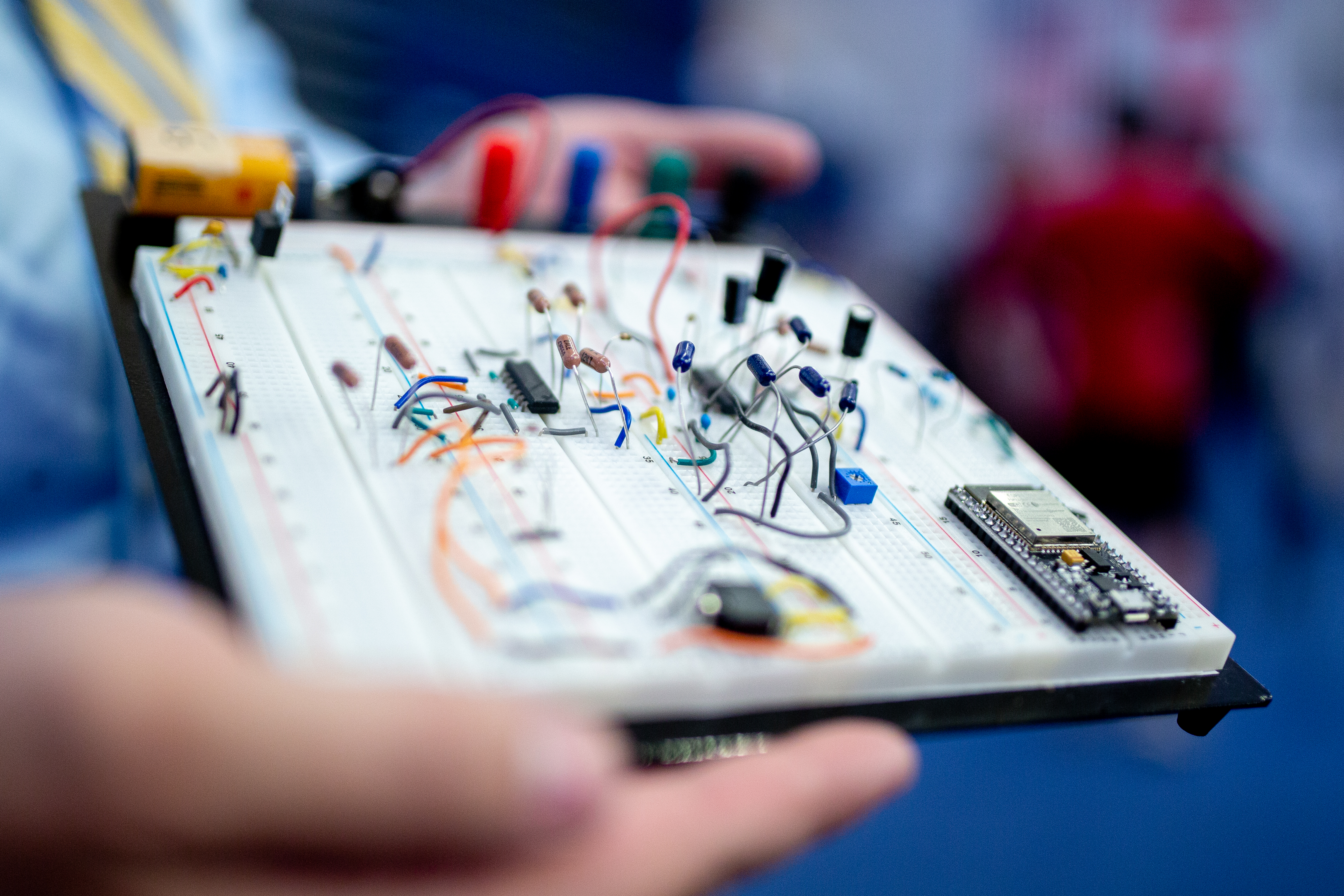 hands holding a circuit board prototype
