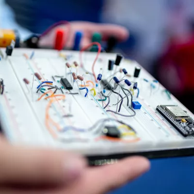 hands holding a circuit board prototype