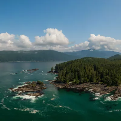 Coastal islands northwest of Vancouver, British Columbia. Lots of green trees on a bluff overlooking the sea.