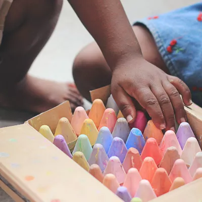 Children drawing with sidewalk chalk.