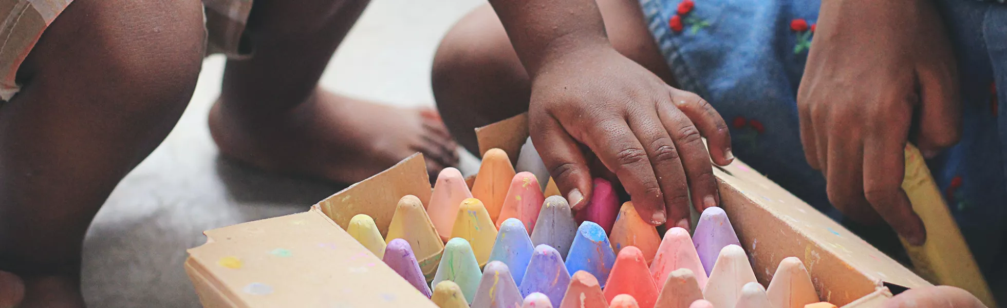 Children drawing with sidewalk chalk.