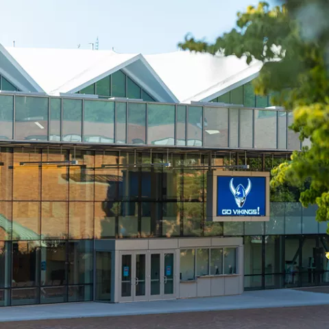 Carver, a modern, glass-covered building with an LED screen reading "Go Vikings!"