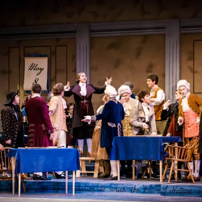 Scene from the musical 1776. Actors playing the signers of the Declaration of Independence are debating each other on stage.