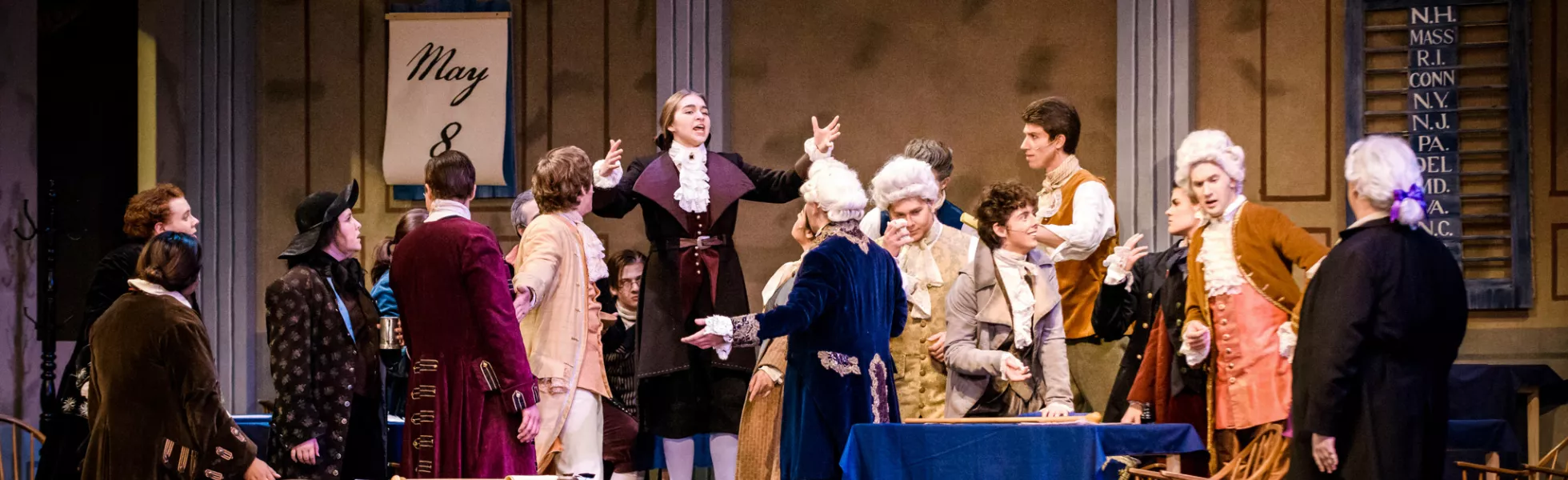 Scene from the musical 1776. Actors playing the signers of the Declaration of Independence are debating each other on stage.