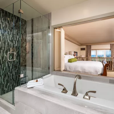 View of Hotel Bellwether's quite ornate bathroom with marble sink and shower base.