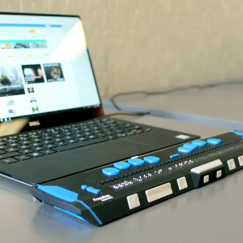 Adaptive keyboard next to a laptop