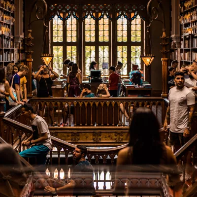 Students studying in an old, wood trimmed library