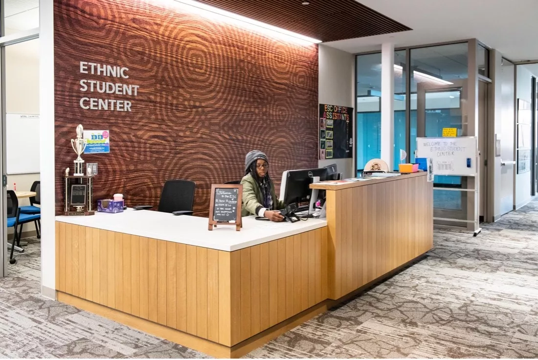 A student working the reception desk at the Ethnic Student Center