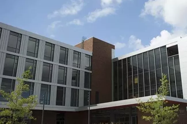 Everett University Center building with windows in front of a blue sky with clouds