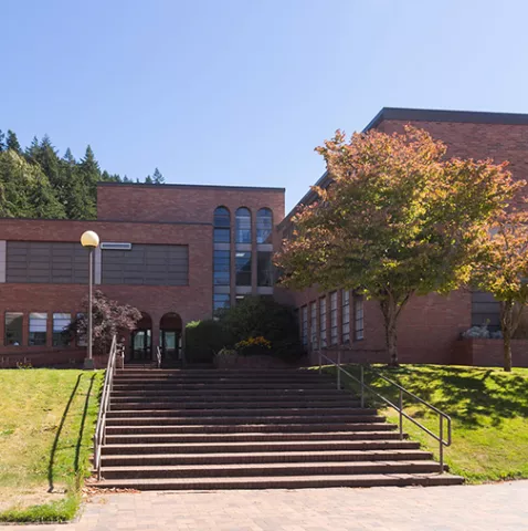 Stairs leading up to Fine Arts, a two story brick building.