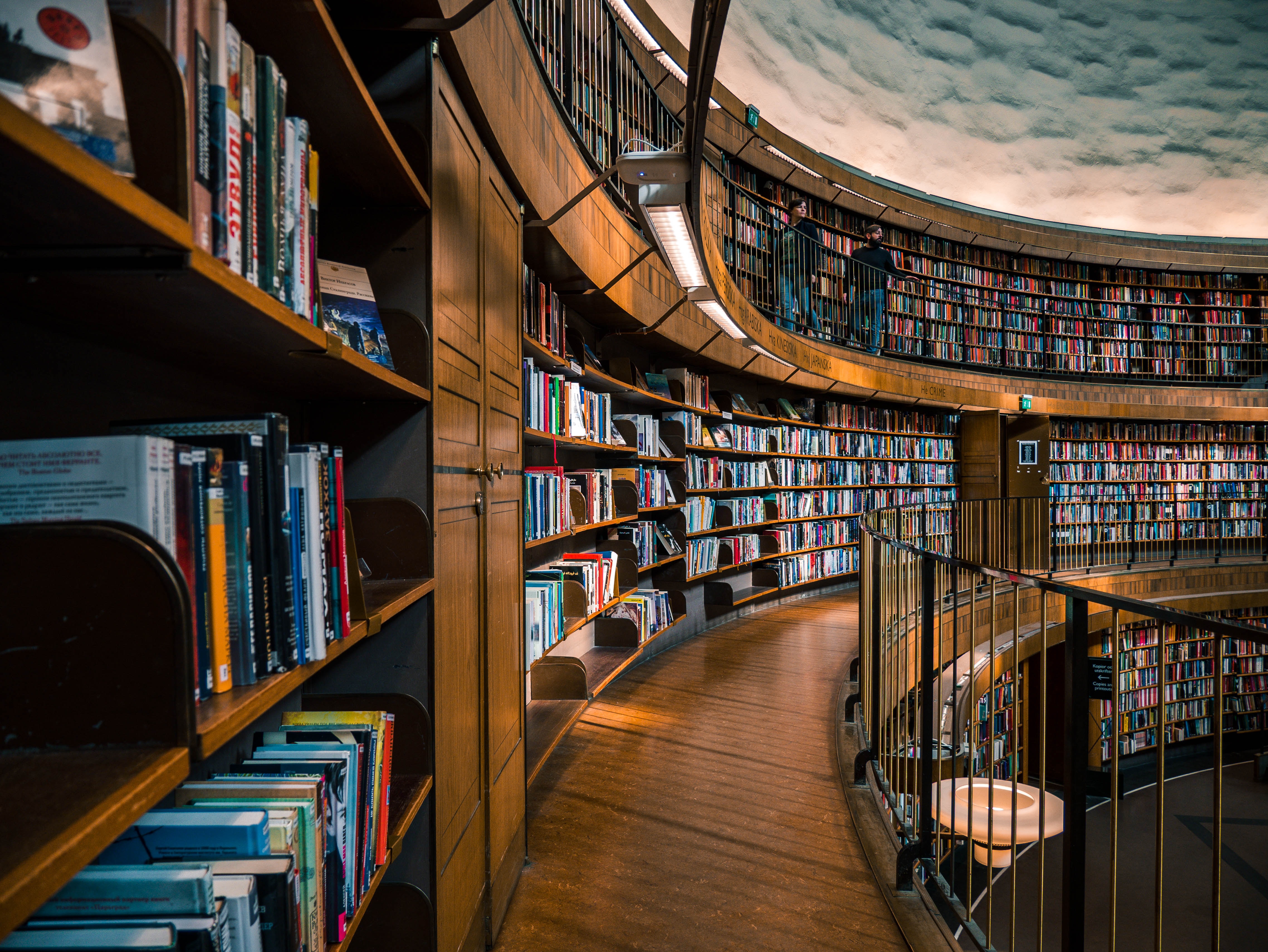 Sprawling, curved wooden shelves of books