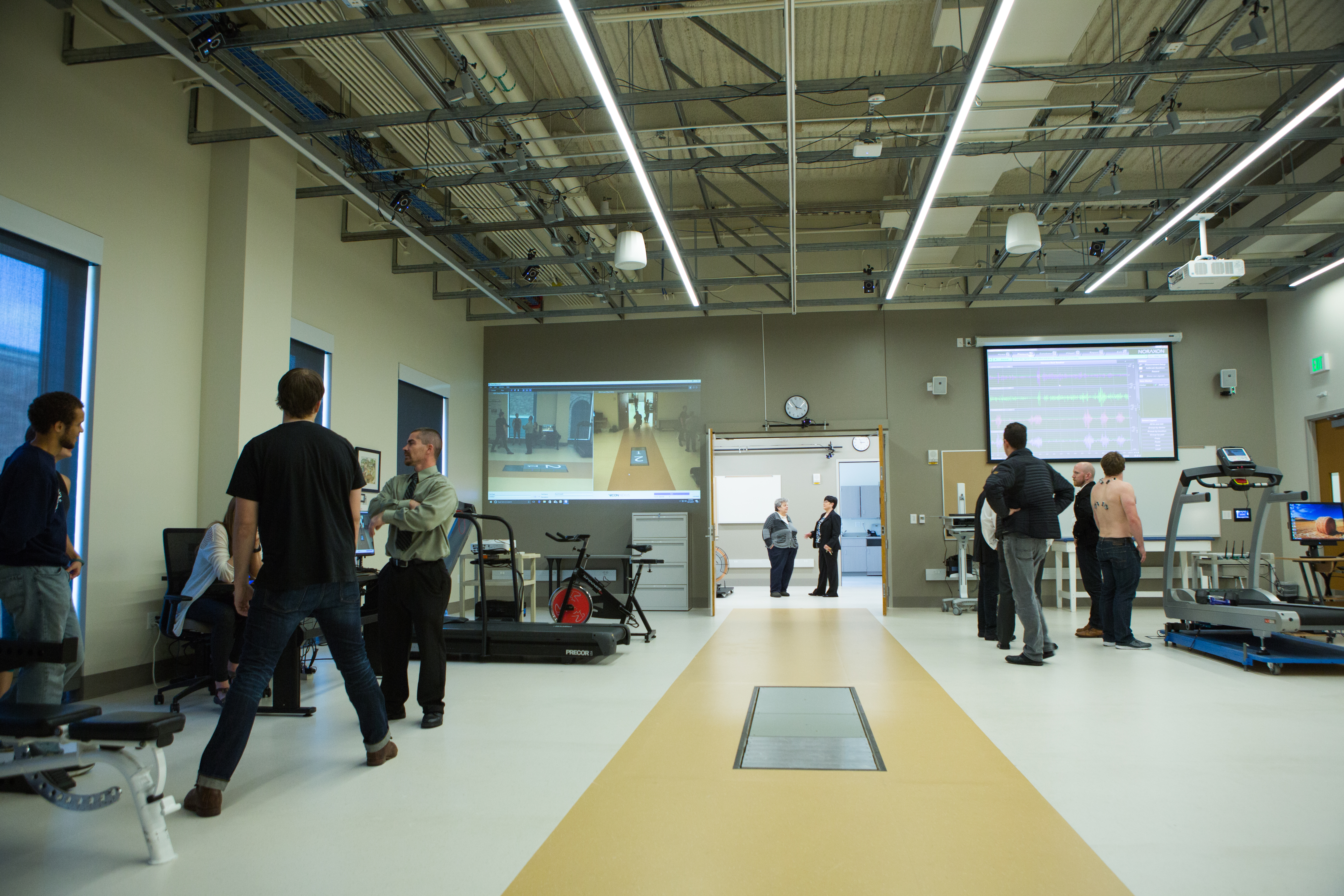 People working at different stations in a kinesiology lab