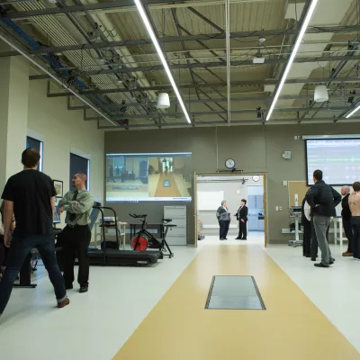 People working at different stations in a kinesiology lab