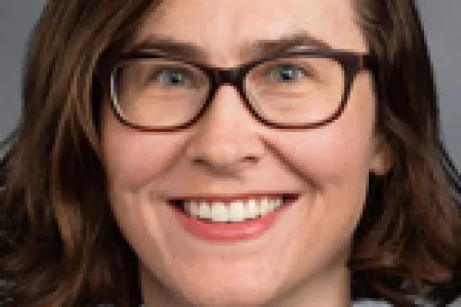 Senator Liz Lovelett wearing glasses and a black top.