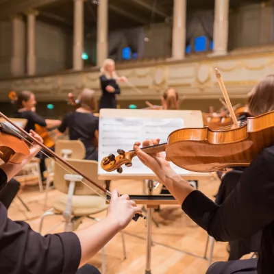 Two people playing violin