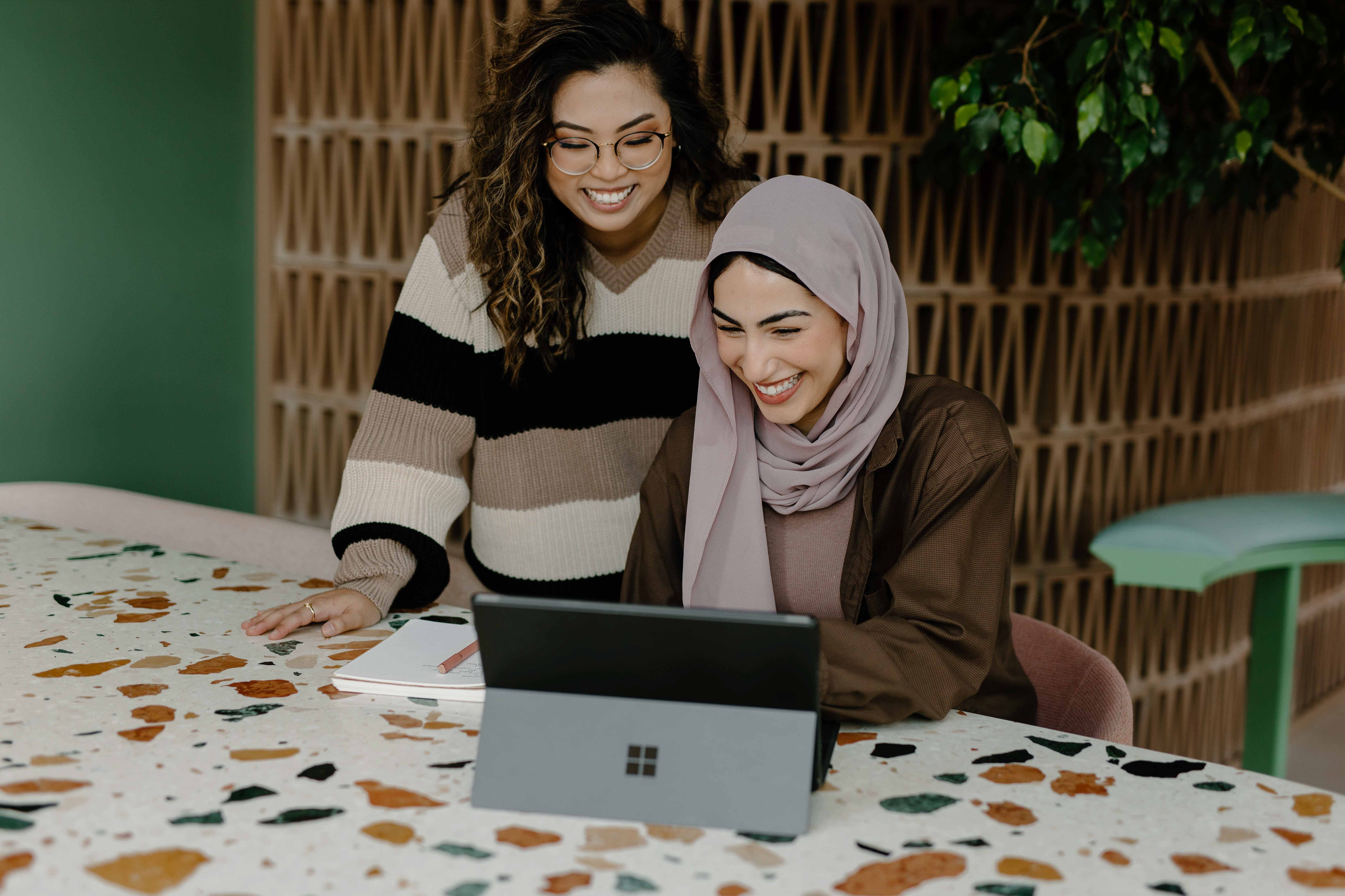 Two women working on a tablet