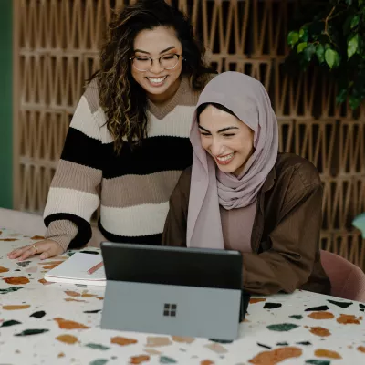 Two women working on a tablet