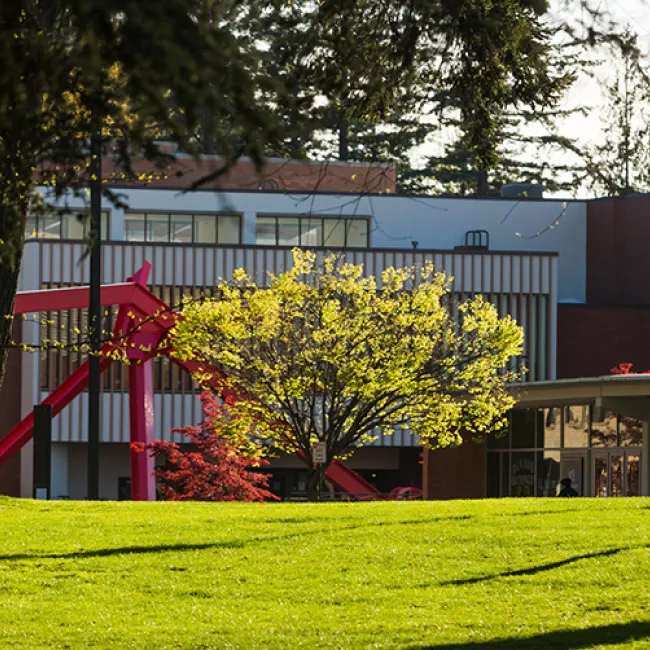 The Performing Arts Center sits behind a large, angular red sculpture.