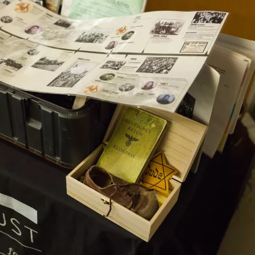 Various items, including a book, shoe and Star of David, sit on a table.