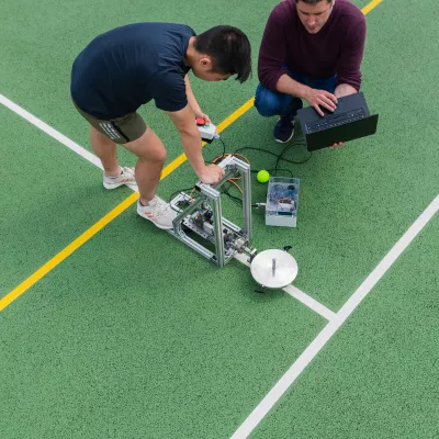 Soccer player working with research equipment on the field