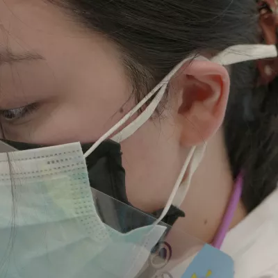 Close-up of a medical professional wearing medical masks.