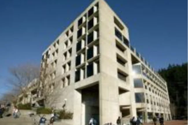 Concrete academic building with large windows at Western Washington University, surrounded by students and outdoor steps