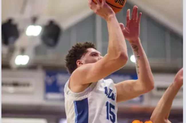 Western basketball player shooting the ball in the gym.
