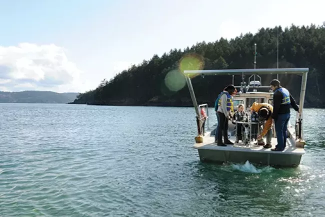 Four people on a square boat in Bellingham Bay